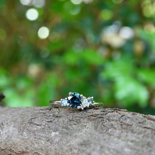 ‘Rockpool’ 0.68ct Australian Blue Sapphire & Diamond Platinum Ring on wood