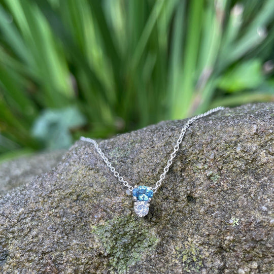 ‘Zoya’ Aquamarine & Diamond White Gold necklace & earrings on top of stone