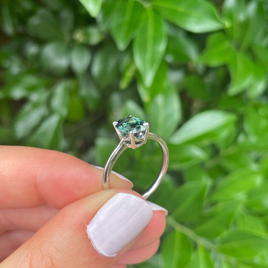 Holding the "HighWire" 1.69ct teal Australian sapphire and platinum ring