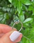 Holding the "HighWire" 1.69ct teal Australian sapphire and platinum ring